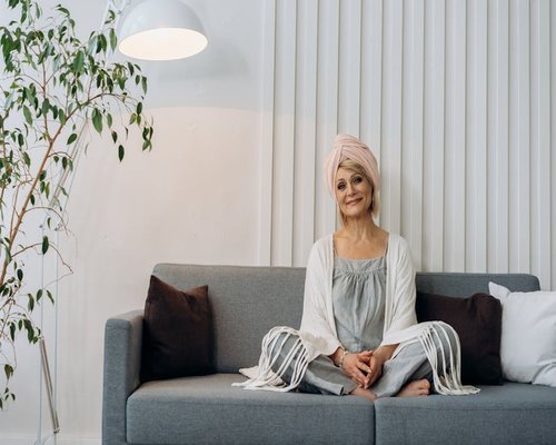 mature woman smiling in bright living room environment